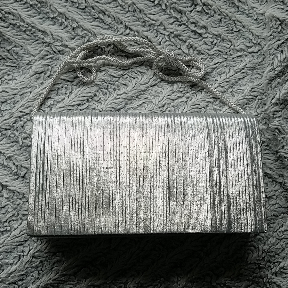 Silver convertible handbag with knife pleats by La Regale